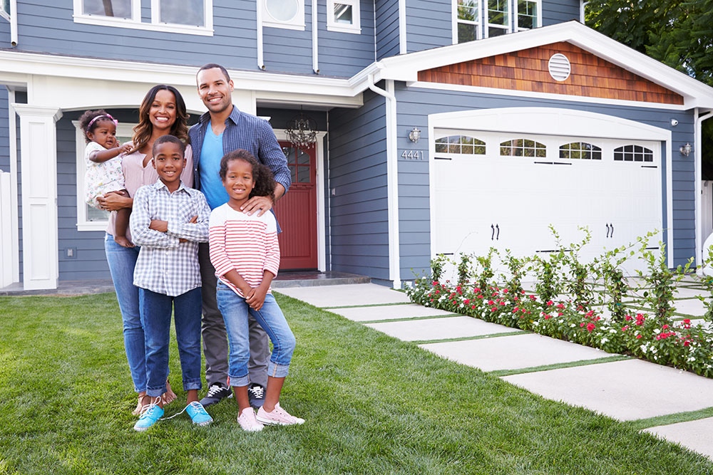 happy family in front of home