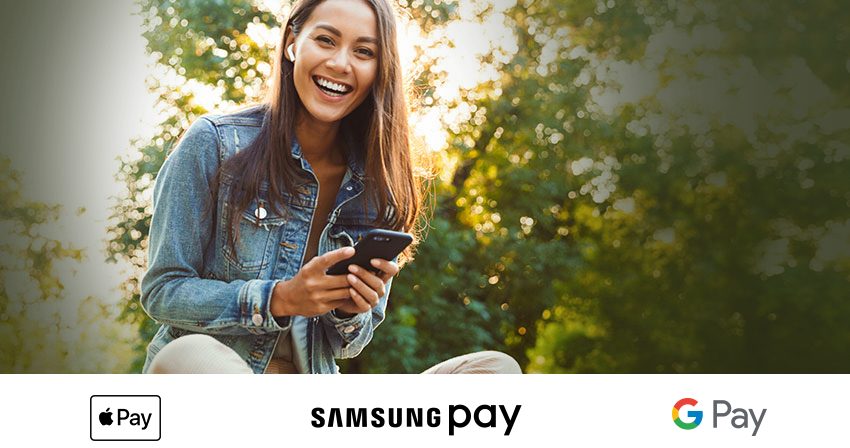 woman sitting with a cell phone smiling